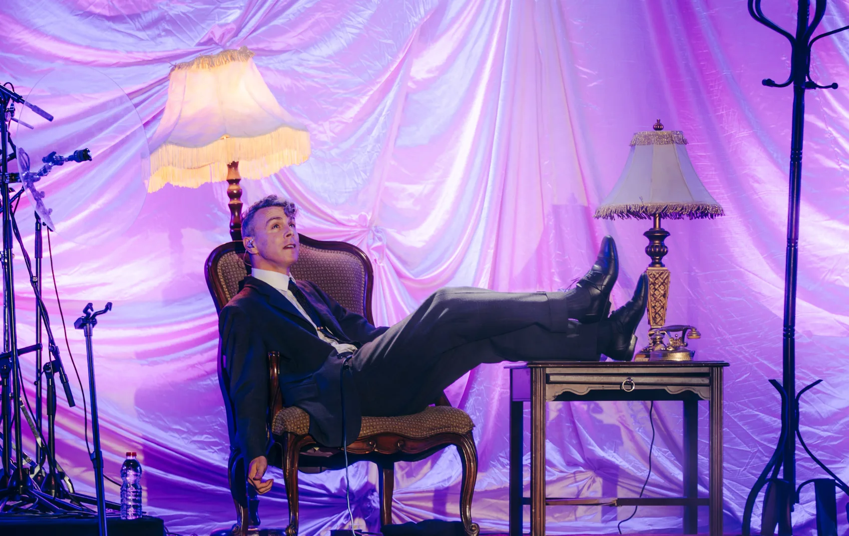 Asaf Avidan performing in a theatrical stage set