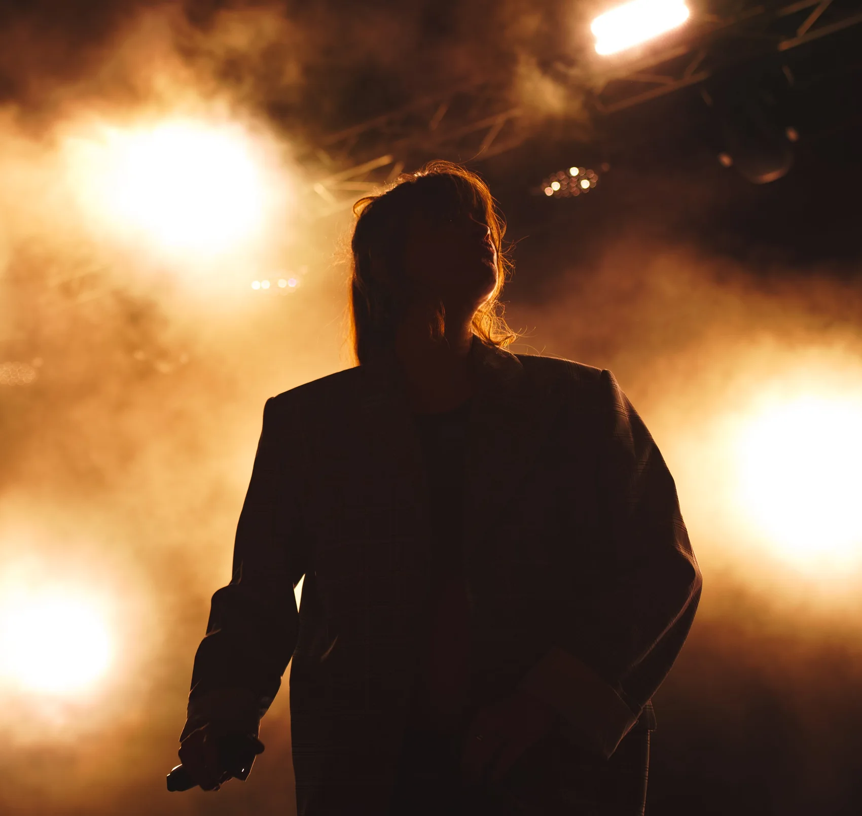 Noga Erez silhouetted against stage light