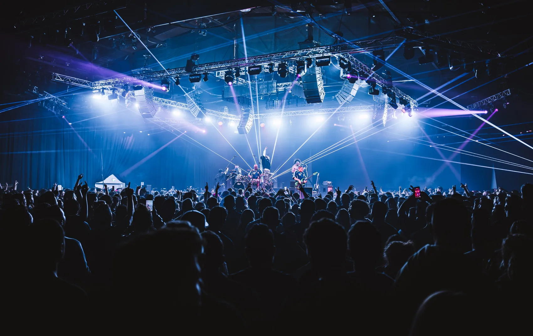 Peled performing under blue stage lights