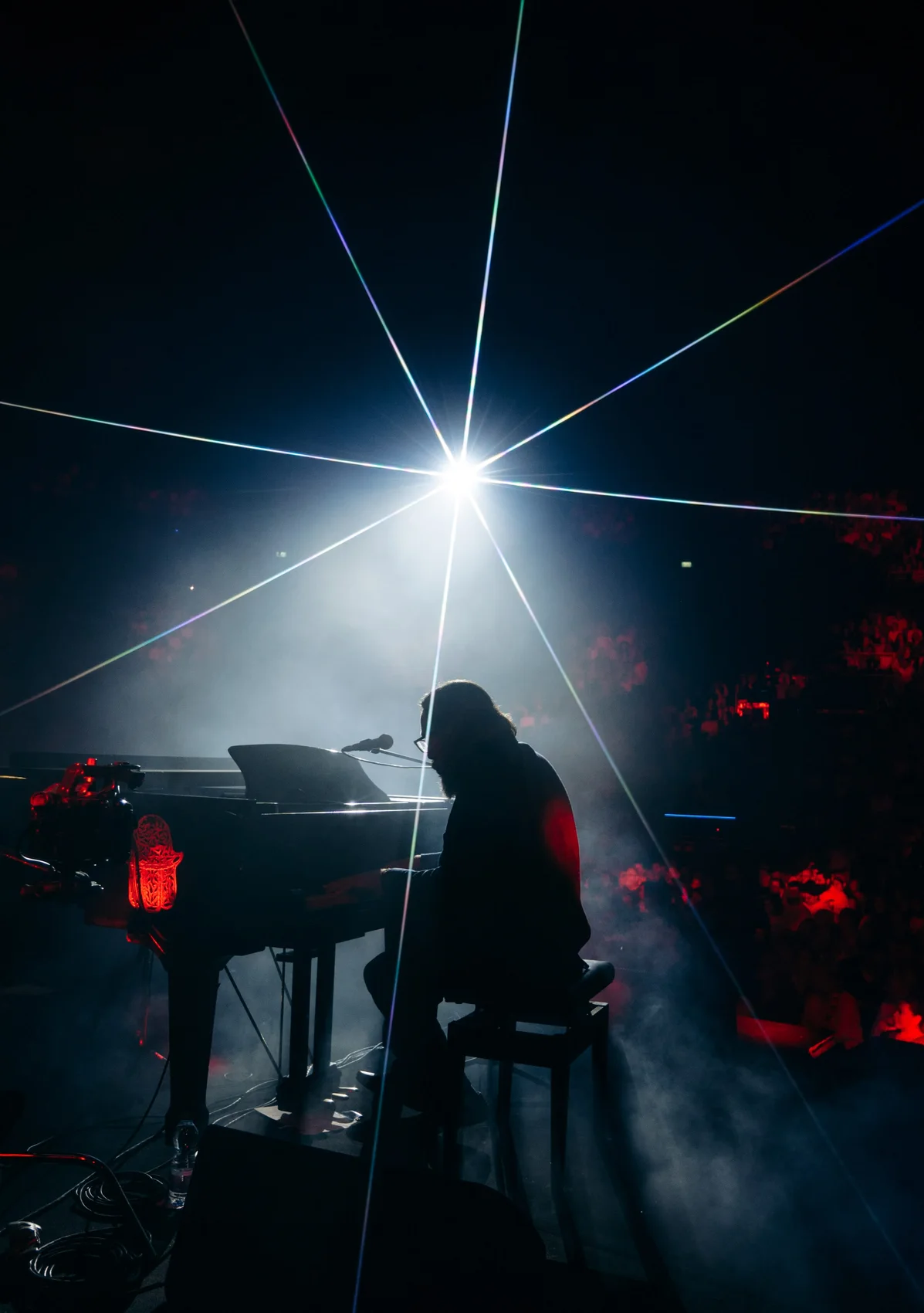 Shuli Rand in silhouette beneath a starburst light