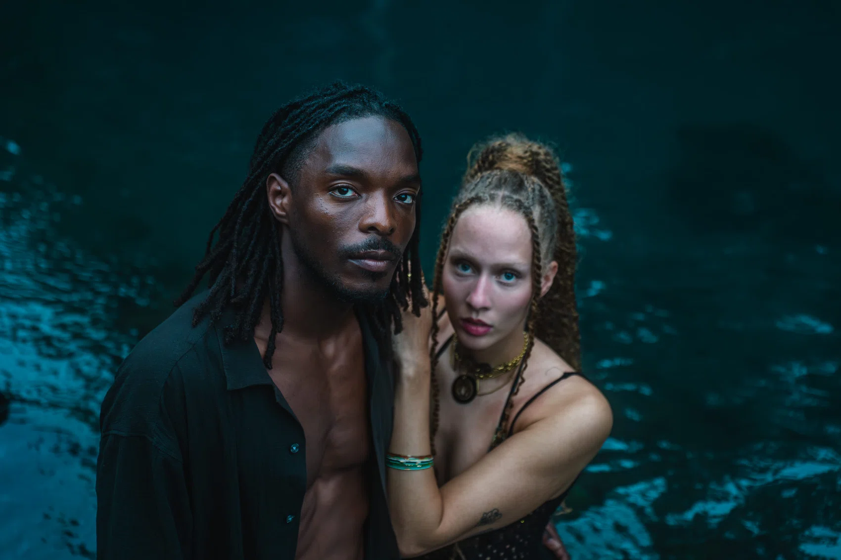 Editorial portrait of two people immersed in water