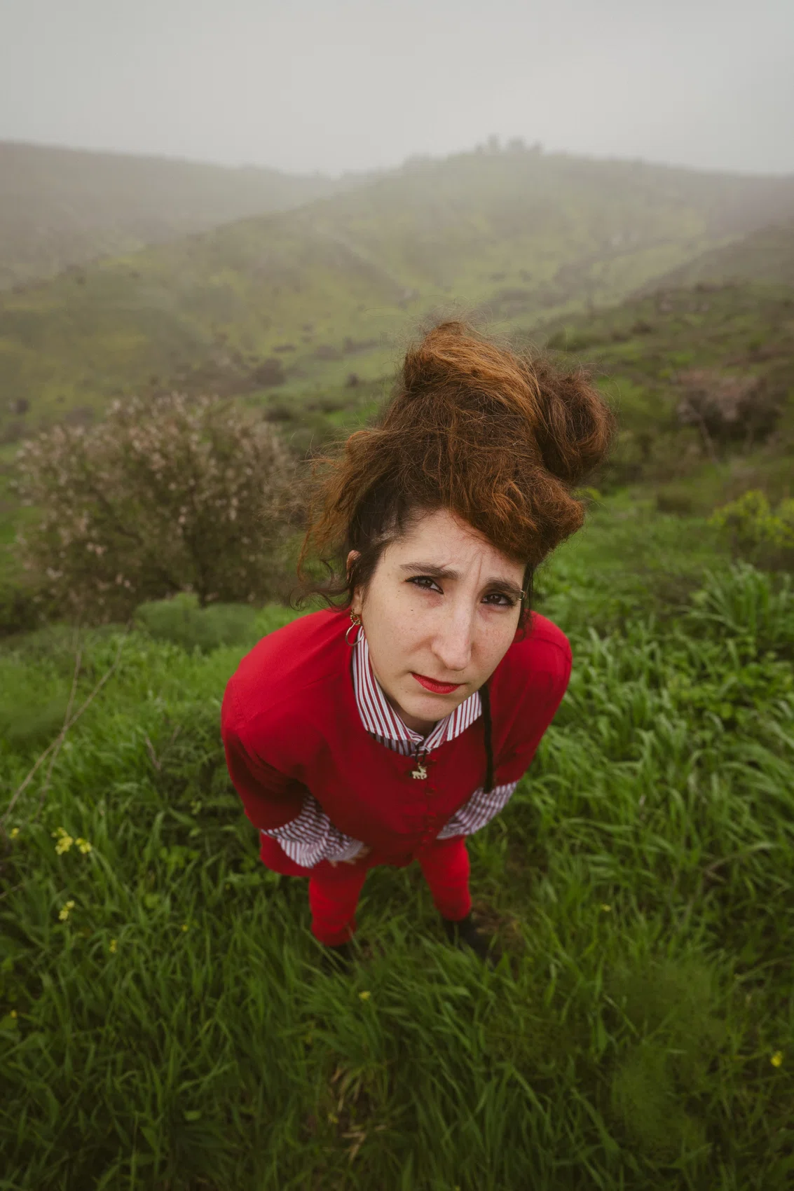 Talya in a red dress in a green landscape