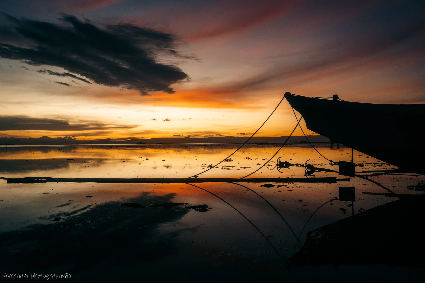 Silhouetted figure reflected beneath a dramatic sunset
